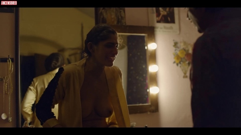 Kubra Sait in a short skirt breasts